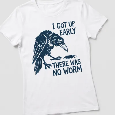 Bold illustration of a grumpy raven with text about early rising and no worm — printed on a women's shirt