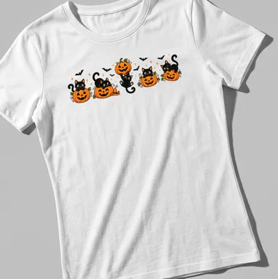 Kawaii cartoon of black cats with pumpkins in orange, black, green, and white — printed on a women's shirt