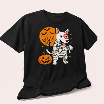 Cartoonish mummy dog in Halloween colors of orange, black, white, green, and yellow — printed on a unisex t-shirt (angled view)