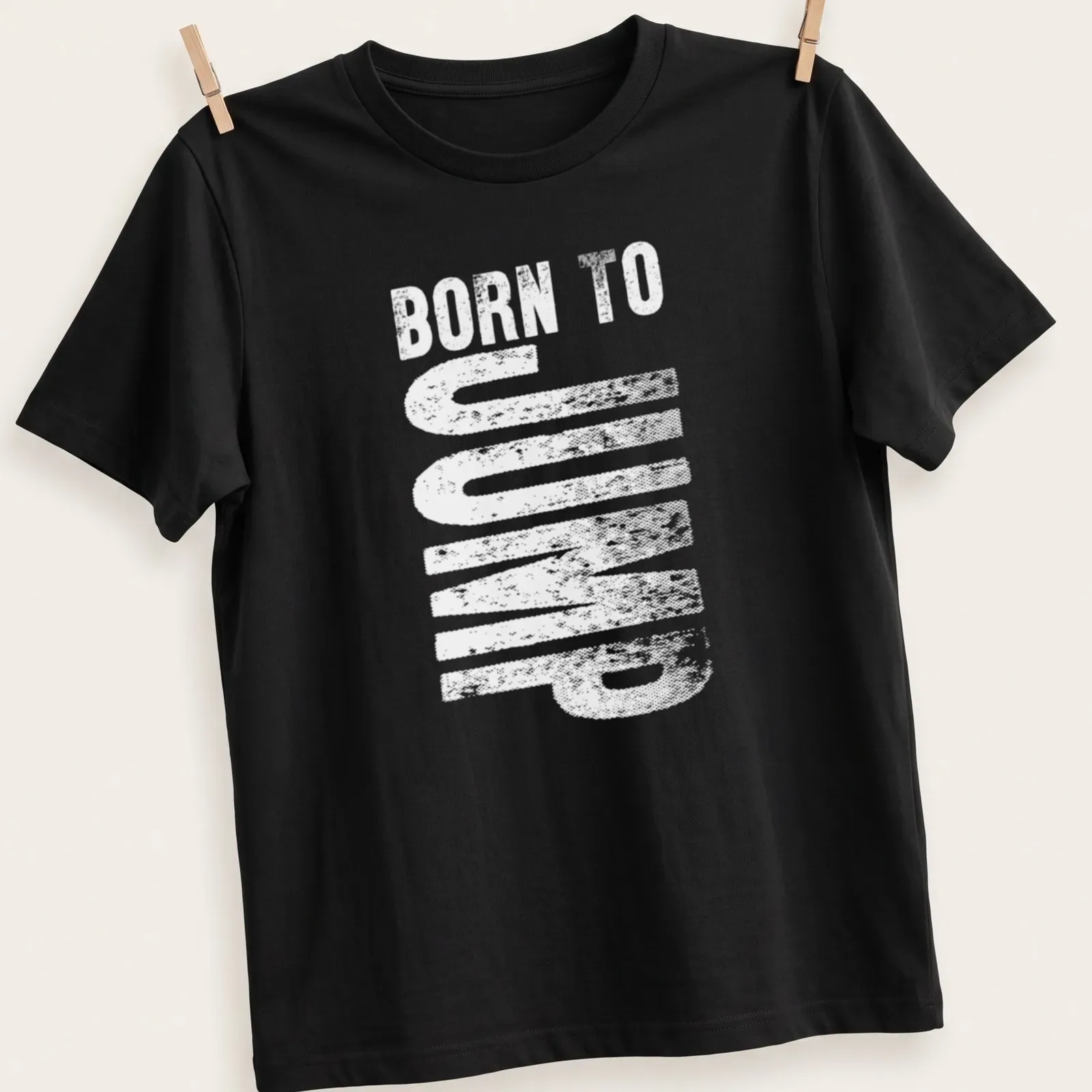 Bold typography t-shirt proclaiming 'Born To Jump' in black and white — printed on a unisex t-shirt