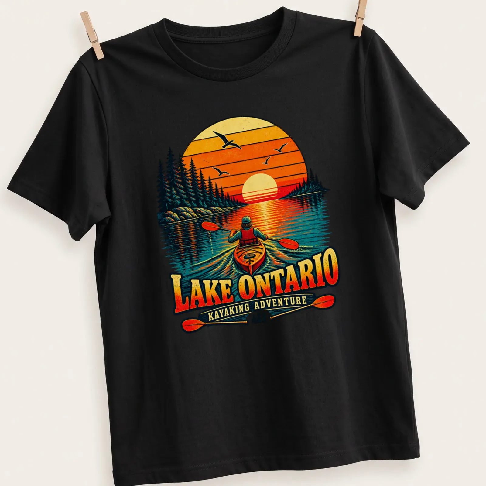 Nostalgic kayaking sunset graphic on Lake Ontario T-shirt in warm colors — printed on a unisex t-shirt