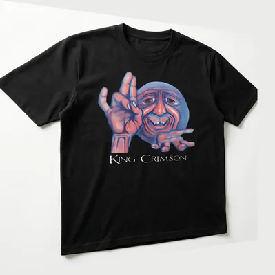 Colorful illustration of a smiling character with King Crimson text above — printed on a unisex t-shirt (angled view)