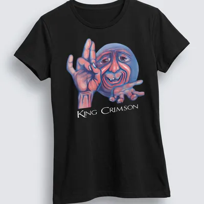 Colorful illustration of a smiling character with King Crimson text above — printed on a women's shirt