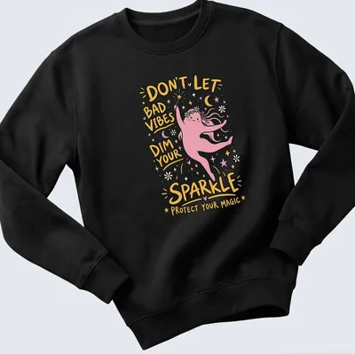Playful cartoon t-shirt featuring a magic character with vibrant colors and positive text — printed on a unisex sweatshirt
