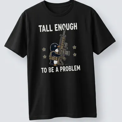 Cartoon penguin with a gun and the text 'Tall Enough To Be A Problem' in black and white