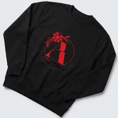 Floral initial letter print in modern typography with red, black, and white colors — printed on a unisex sweatshirt