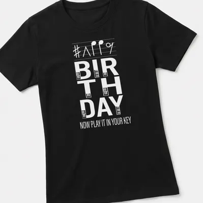 Typography design featuring musical notes and birthday wishes for pianists — printed on a women's shirt