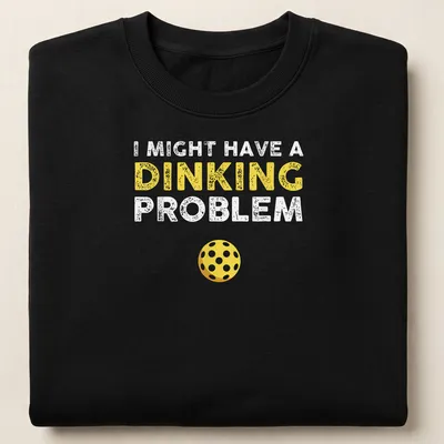 Funny pickleball shirt saying I Might Have A Dinking Problem in yellow and white — printed on a unisex sweatshirt