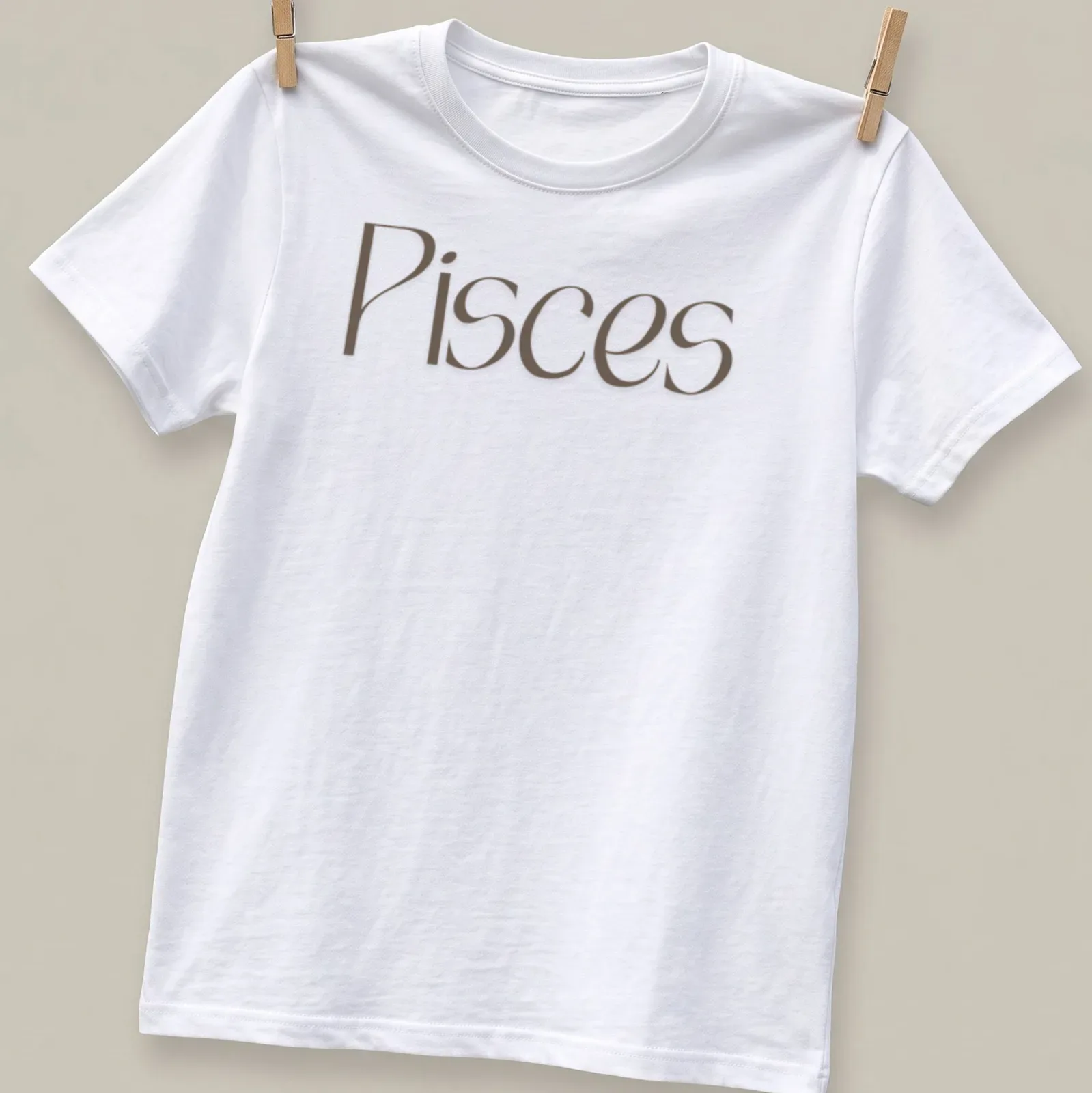 Elegant Pisces zodiac sign t-shirt in serif font with brown and white colors — printed on a unisex t-shirt