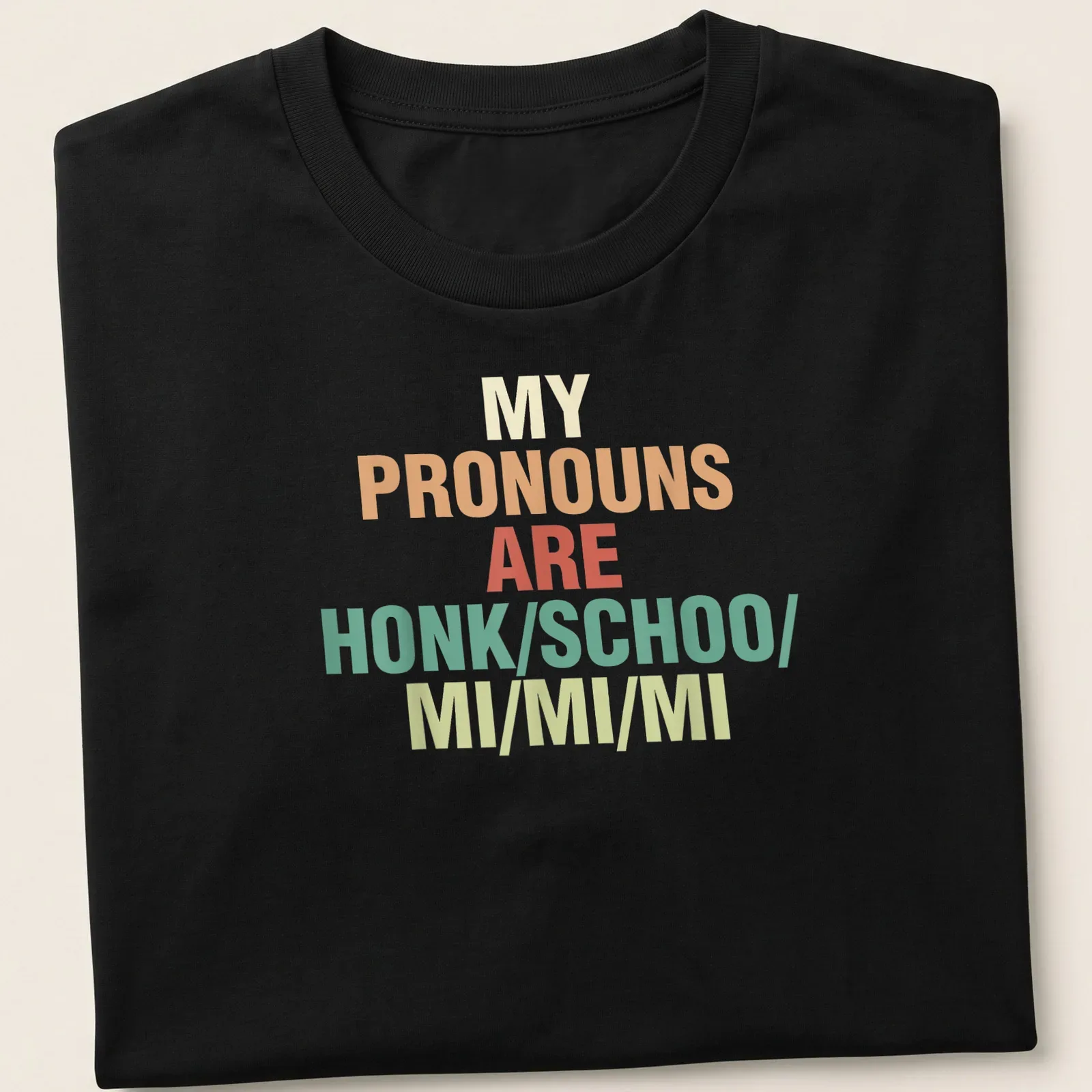 Colorful typography t-shirt with the phrase about pronouns in bold text — printed on a unisex t-shirt