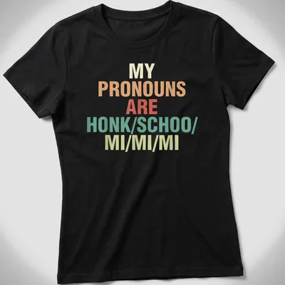 Colorful typography t-shirt with the phrase about pronouns in bold text — printed on a women's shirt
