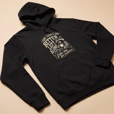 Vintage illustration of a raccoon with humorous text about solitude. — printed on a unisex hoodie