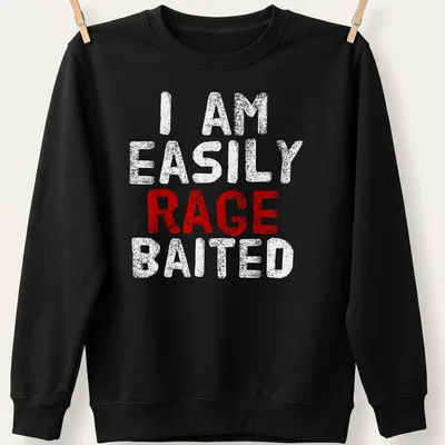 Bold distressed t-shirt reading 'I AM EASILY RAGE BAITED' in red and white — printed on a unisex sweatshirt