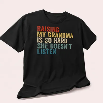 Humorous t-shirt with vintage distressed text about raising a grandma — printed on a unisex t-shirt (angled view)