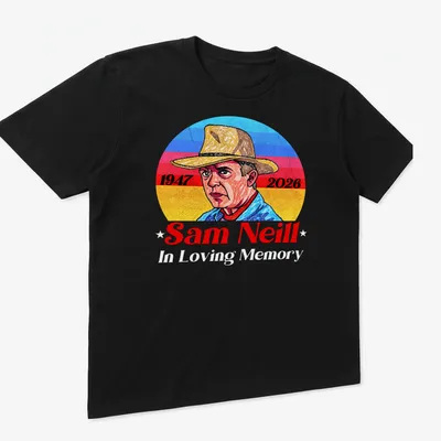 Vintage portrait tribute to Sam Neill with 1947 and 2026 dates in blue, red, yellow, and white. — printed on a unisex t-shirt (angled view)