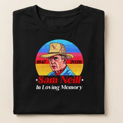 Vintage portrait tribute to Sam Neill with 1947 and 2026 dates in blue, red, yellow, and white. — printed on a women's shirt