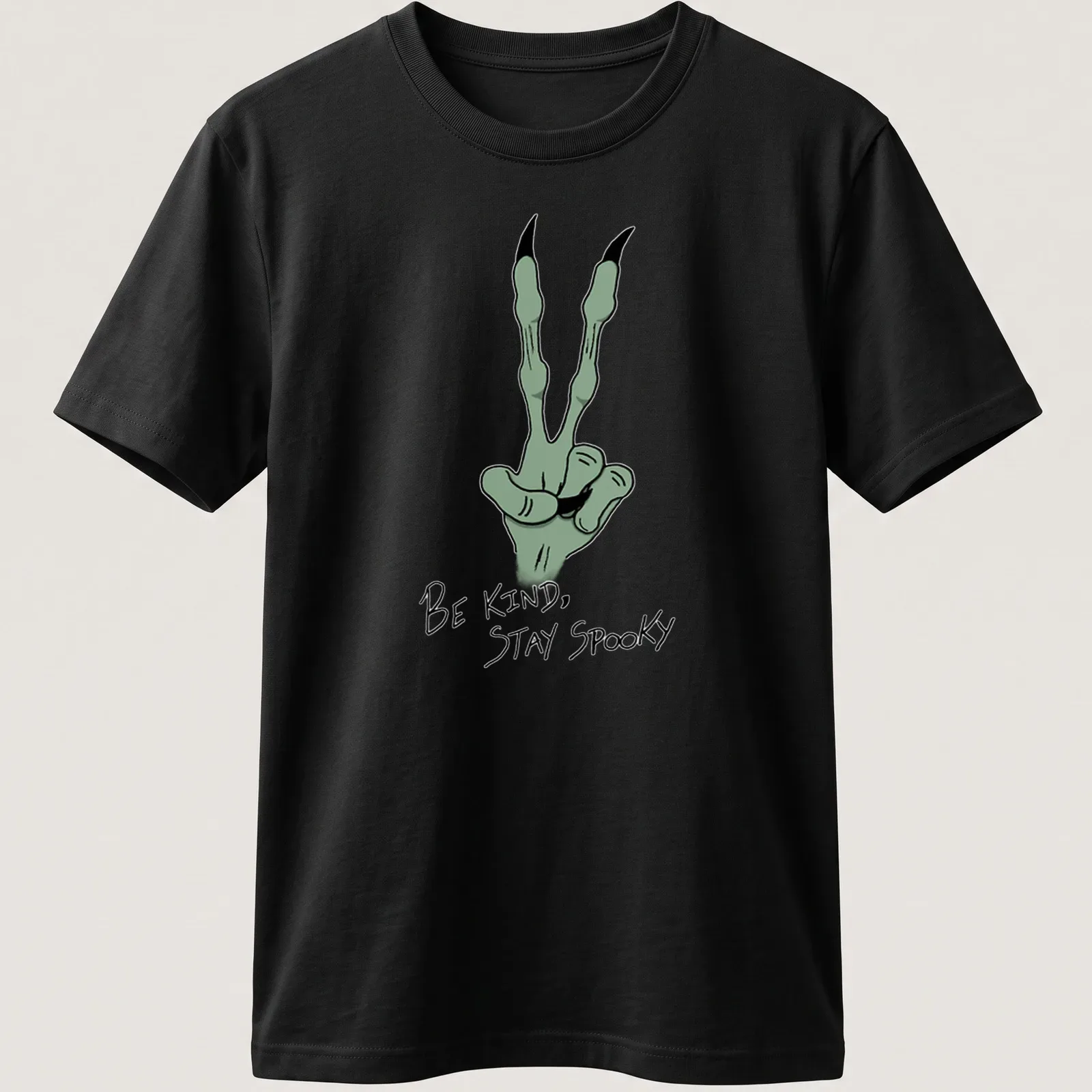 Cartoonish green hand gesture with 'Be Kind, Stay Spooky' text in black and white — printed on a unisex t-shirt