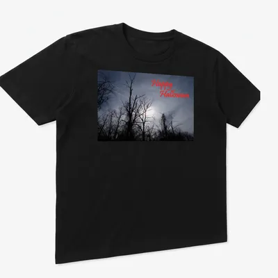 Photographic print of spooky trees with Happy Halloween text in red — printed on a unisex t-shirt (angled view)