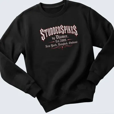 Old English text logo of Studded Spikes by Djamee in red, black, and white. — printed on a unisex sweatshirt