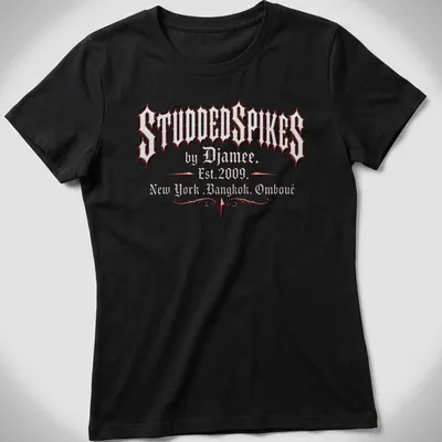 Old English text logo of Studded Spikes by Djamee in red, black, and white. — printed on a women's shirt