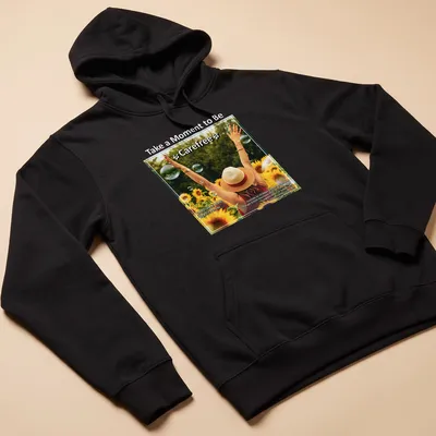 Woman with arms raised in sunflower field, colorful illustration with uplifting text — printed on a unisex hoodie