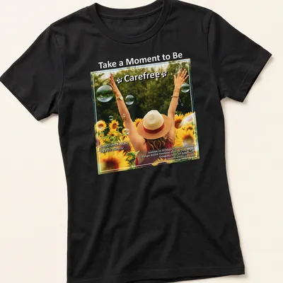 Woman with arms raised in sunflower field, colorful illustration with uplifting text — printed on a women's shirt