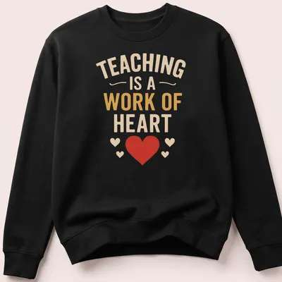 Bold typography shirt with the quote 'Teaching Is A Work Of Heart' in colorful design — printed on a unisex sweatshirt