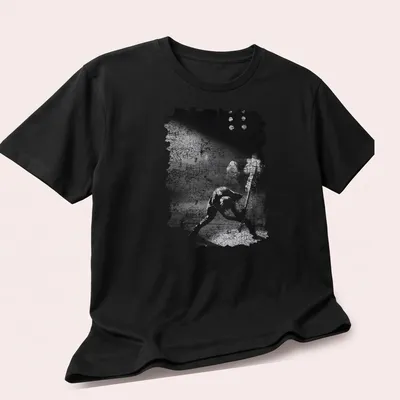 Black and white grunge T-shirt featuring The Clash in a punk rock style — printed on a unisex t-shirt (angled view)