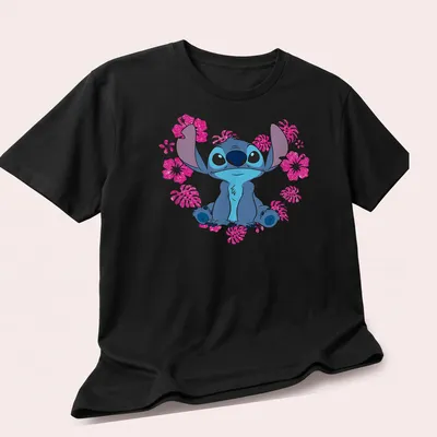 Cartoon alien character Stitch with heart flowers in blue, pink, white, and green. — printed on a unisex t-shirt (angled view)