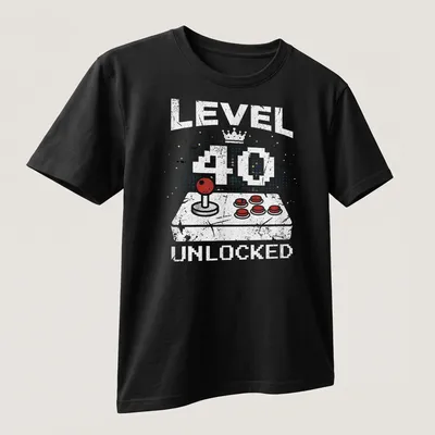 Retro distressed t-shirt with 'LEVEL 40 UNLOCKED' above a video game controller in bright colors — printed on a unisex t-shirt (angled view)