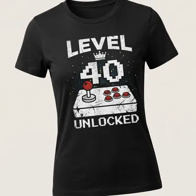 Retro distressed t-shirt with 'LEVEL 40 UNLOCKED' above a video game controller in bright colors — printed on a women's shirt