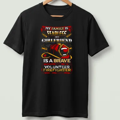 Vintage-style t-shirt celebrating a brave volunteer firefighter girlfriend with bold text and helmet graphic.