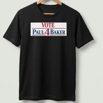 Bold typography t-shirt displaying 'Vote Paul 4 Baker' in red, blue, and white.
