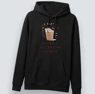 Kawaii illustration of a witch with a cold brew and playful text in brown, cream, and yellow — printed on a unisex hoodie