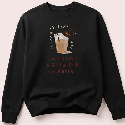 Kawaii illustration of a witch with a cold brew and playful text in brown, cream, and yellow — printed on a unisex sweatshirt