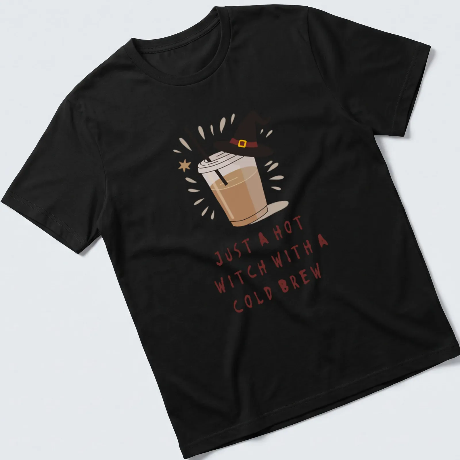 Kawaii illustration of a witch with a cold brew and playful text in brown, cream, and yellow — printed on a unisex t-shirt